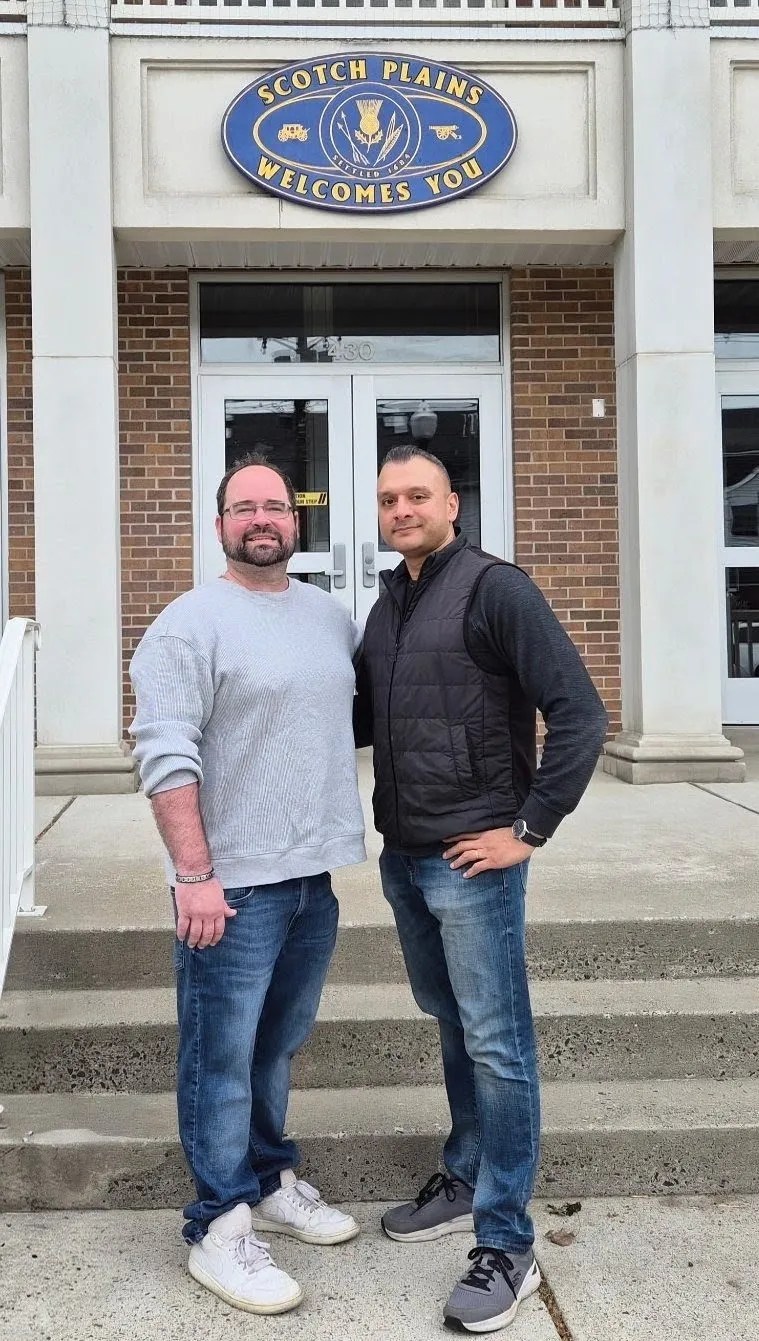Romel D'Munda with a fellow Scotch Plains community member outside a Scotch Plains municipal building
